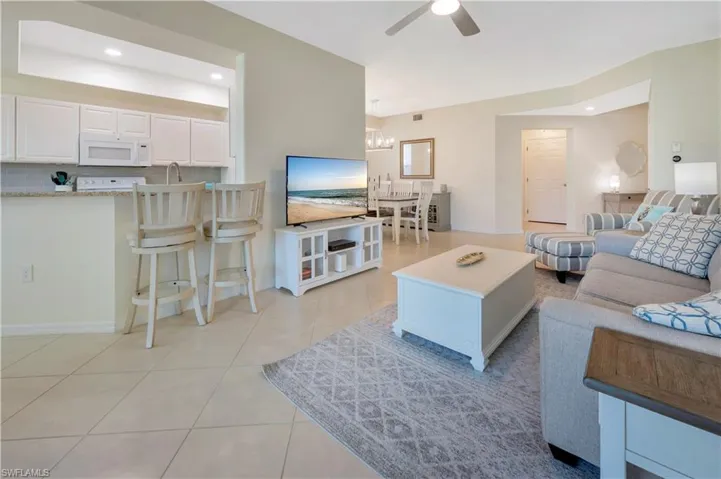 Living area with recessed lighting, a ceiling fan, and light tile patterned floors
