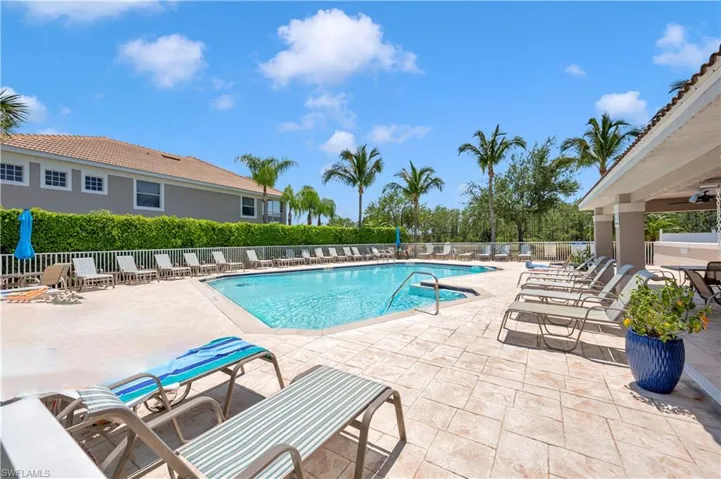 Community pool with a patio