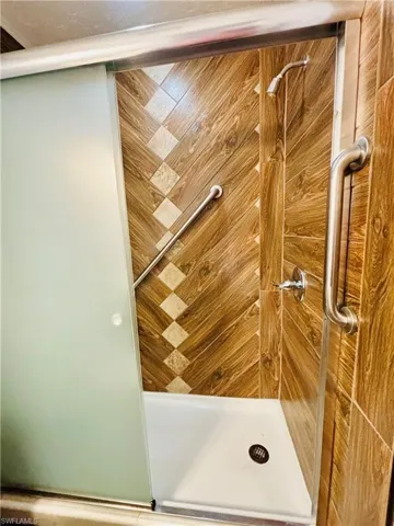 Bathroom view of a shower with shower door