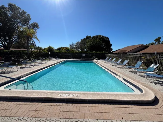 Community pool with a patio