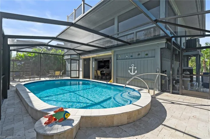 Outdoor pool featuring glass enclosure and a patio area