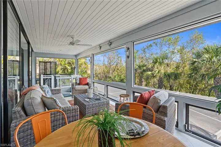Sunroom with a ceiling fan and outdoor dining area