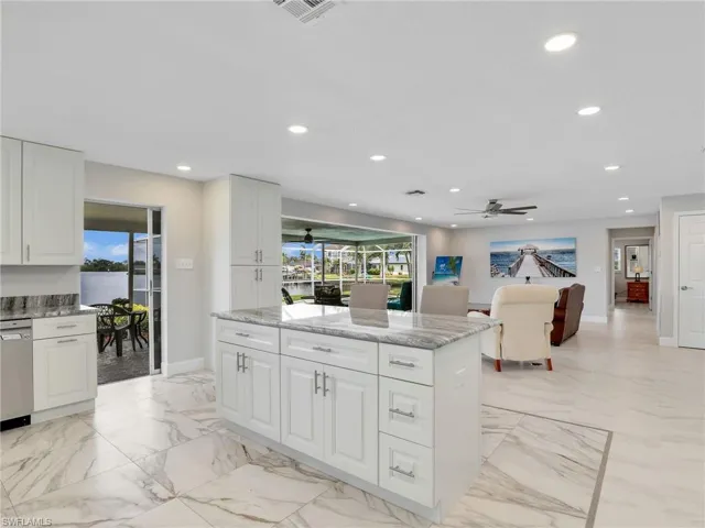 Kitchen featuring a water view, recessed lighting, and marble finish floors