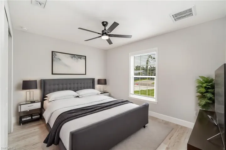 Bedroom with ceiling fan and light hardwood / wood-style flooring