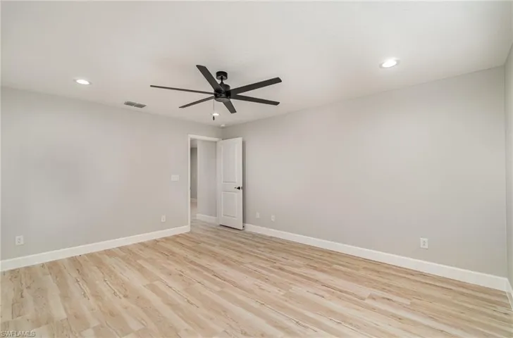 Unfurnished room with light hardwood / wood-style flooring and ceiling fan