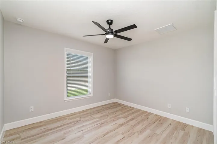 Unfurnished room with ceiling fan and light hardwood / wood-style floors