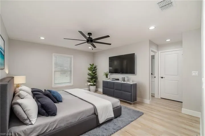 Bedroom featuring light hardwood / wood-style floors and ceiling fan