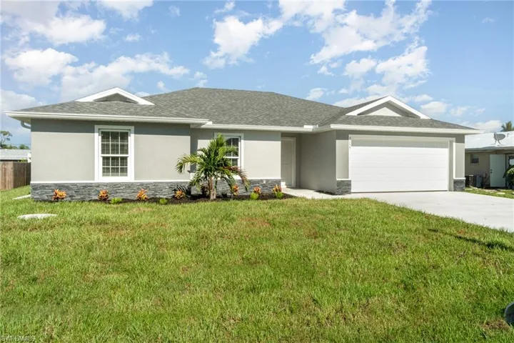 Ranch-style home with a garage and a front yard