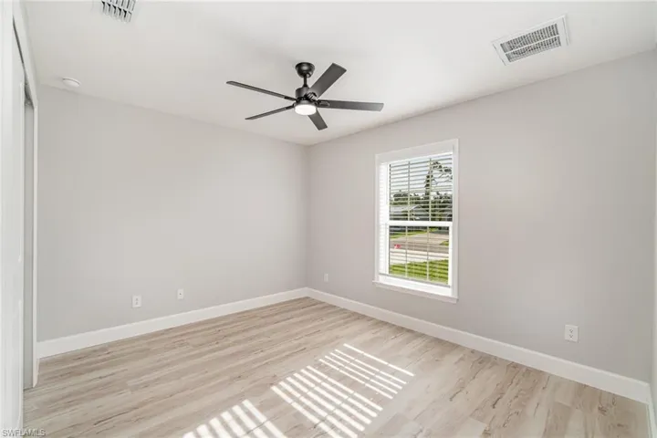 Unfurnished room featuring light hardwood / wood-style floors and ceiling fan
