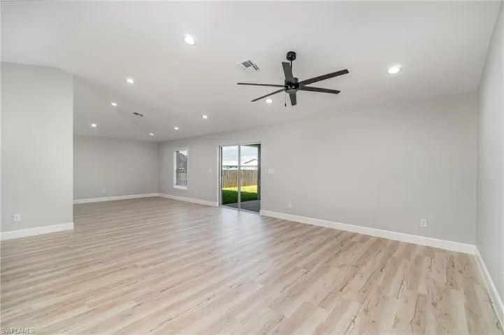 Empty room featuring light wood-type flooring and ceiling fan