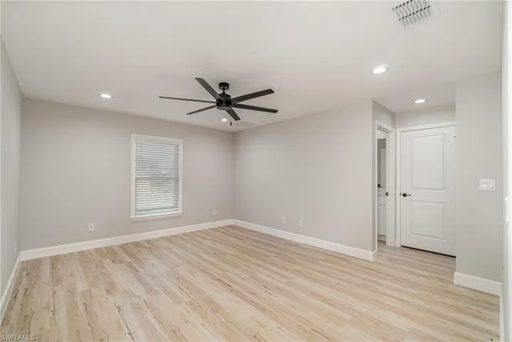 Unfurnished room with light hardwood / wood-style floors and ceiling fan