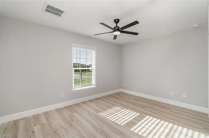 Unfurnished room featuring light hardwood / wood-style flooring and ceiling fan