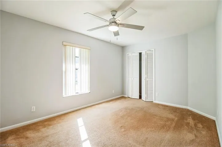Spare room with light colored carpet and ceiling fan