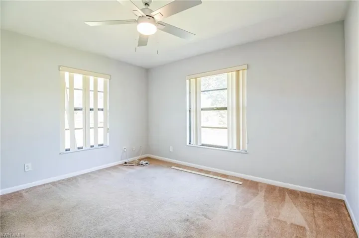Spare room with carpet and ceiling fan