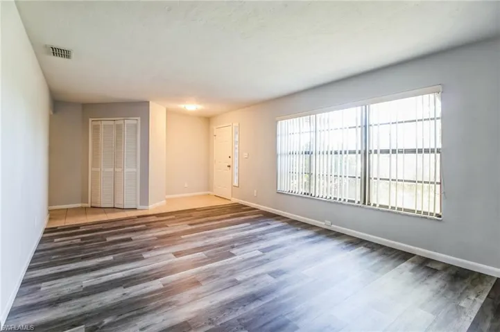 Empty room featuring dark wood-type flooring