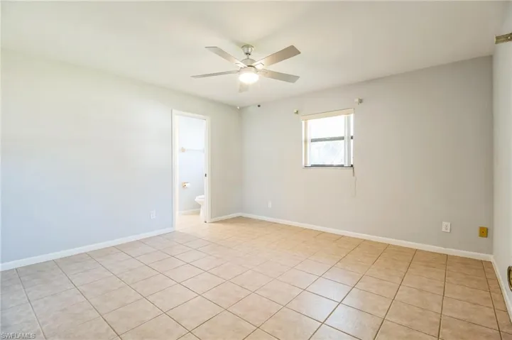 Unfurnished room featuring ceiling fan and light tile patterned floors