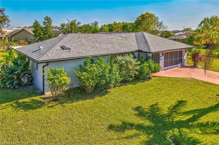 View of front of house with a front yard and a garage