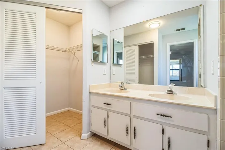 Bathroom featuring tile patterned flooring and vanity