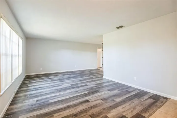 Spare room featuring dark hardwood / wood-style flooring