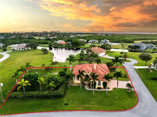 Aerial view at dusk featuring a water view