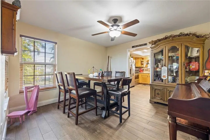 Dining room with light wood-type flooring and ceiling fan
