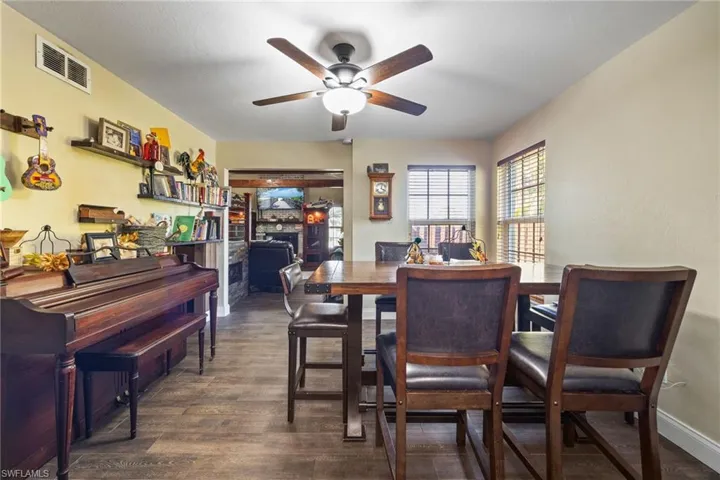 Dining space featuring dark wood-style floors and ceiling fan