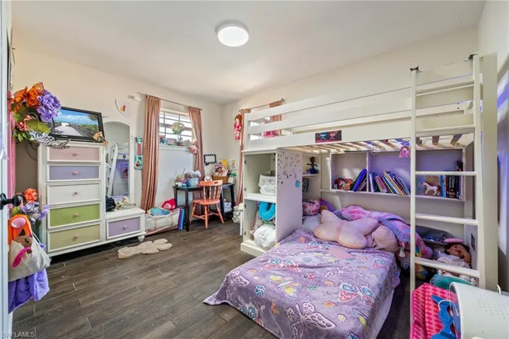 Bedroom featuring dark wood-style flooring