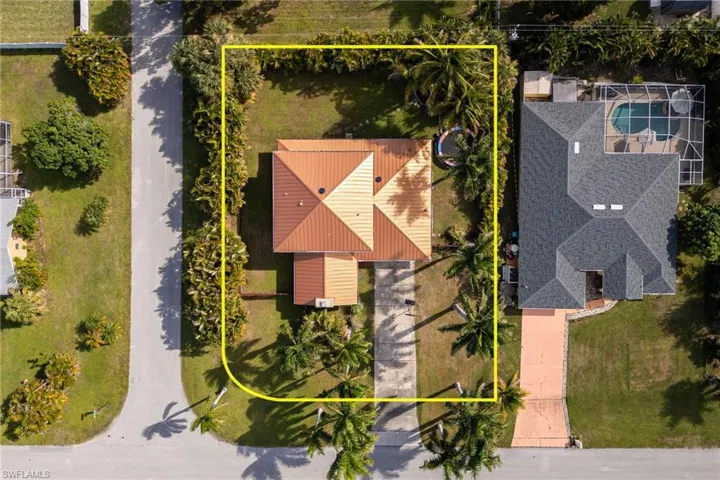 Aerial view of property and surrounding area with property boundaries highlighted