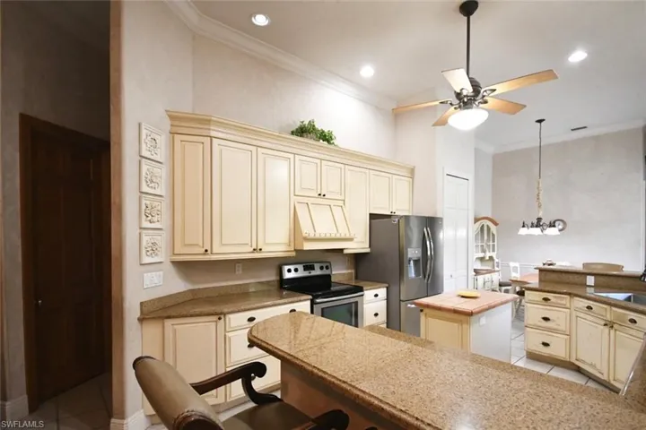 View of kitchen, dining bar and hallway