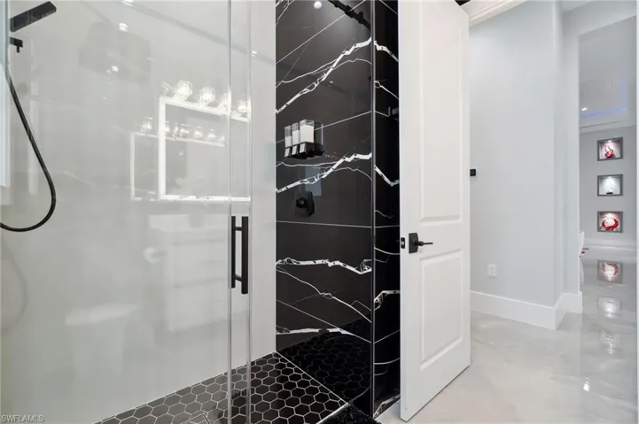Bathroom featuring baseboards and a stall shower