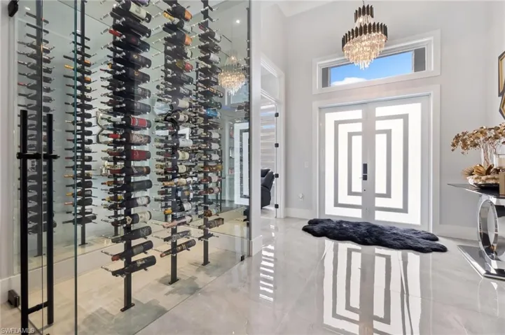 Wine area with baseboards and a chandelier