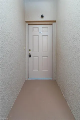 Property entrance with stucco siding