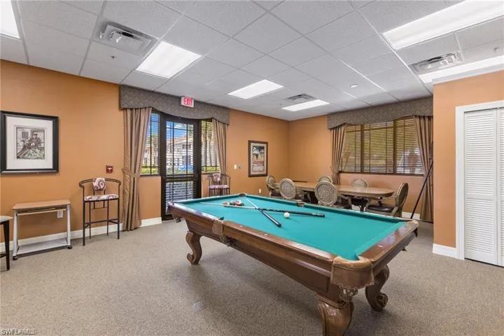 Playroom featuring carpet flooring and a drop ceiling