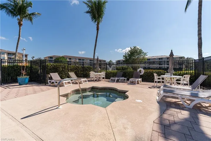 View of pool featuring a patio area and a hot tub