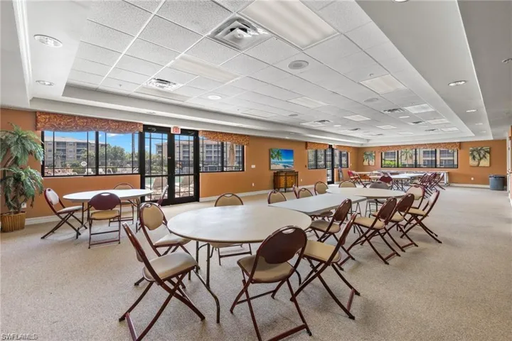 Carpeted dining area featuring a paneled ceiling and a tray ceiling