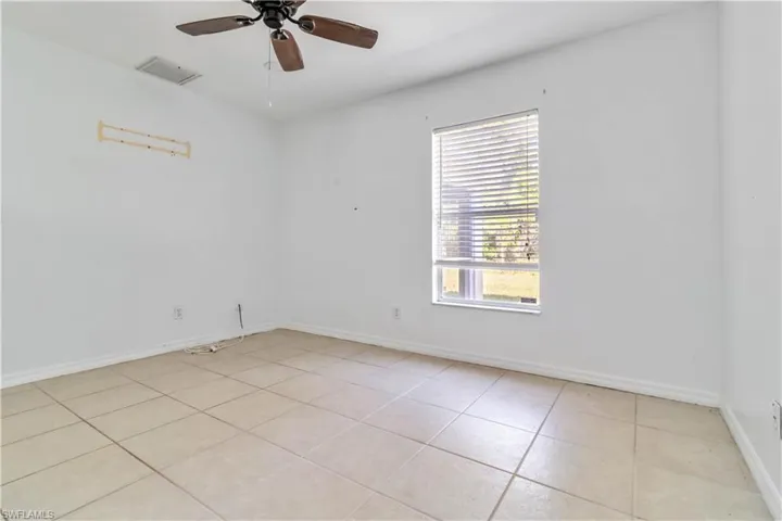 Spare room featuring light tile patterned floors and a ceiling fan