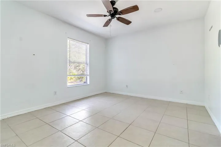 Spare room with light tile patterned floors and ceiling fan