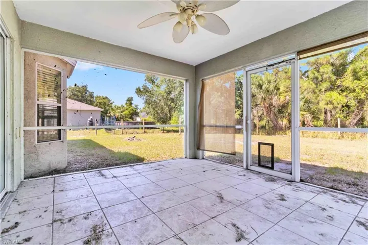 Unfurnished sunroom with ceiling fan