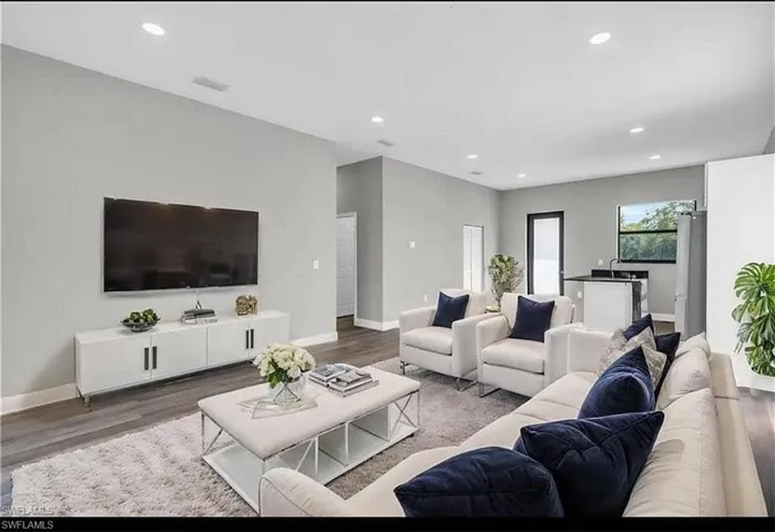 Living area featuring wood finished floors and recessed lighting