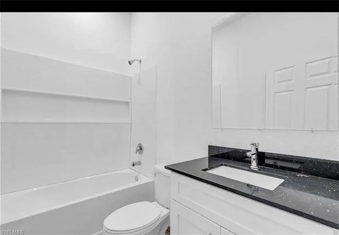 Bathroom featuring vanity and shower / washtub combination