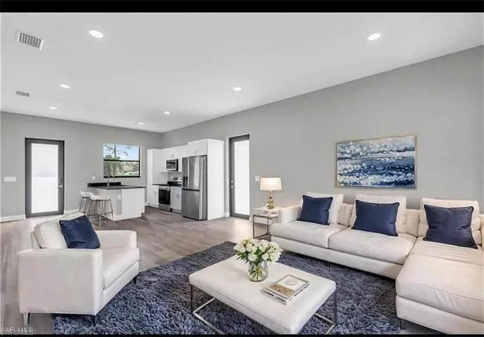 Living area with recessed lighting and light wood-type flooring
