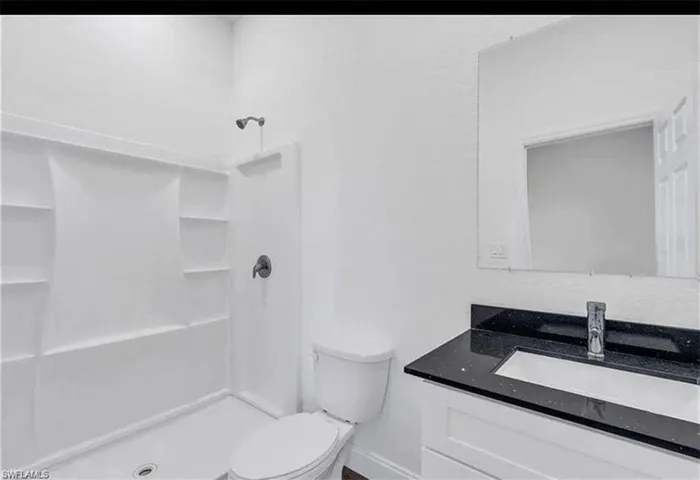 Full bathroom featuring vanity and a stall shower