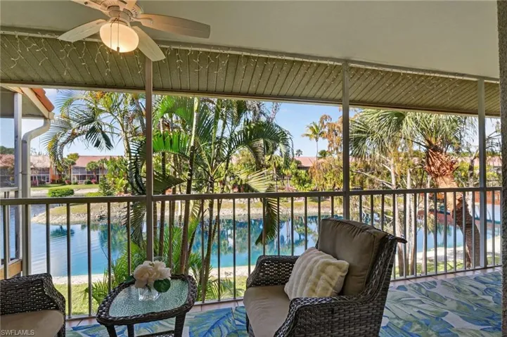 Sunroom featuring a water view