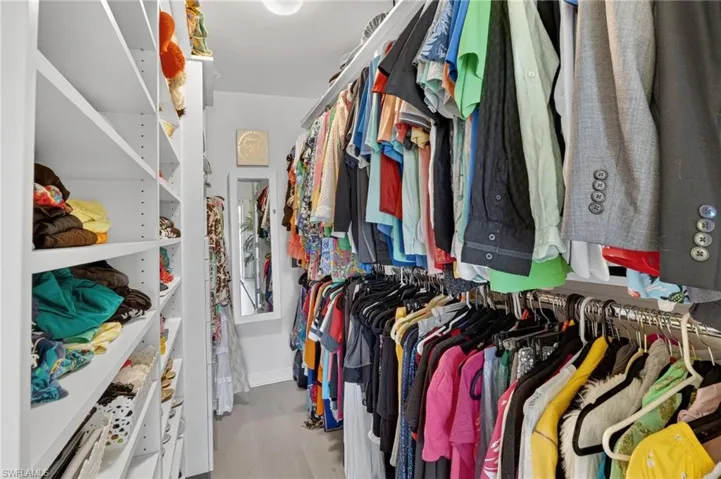 Walk in closet with light wood-type flooring