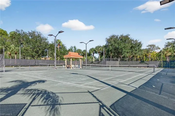 View of tennis court featuring community basketball court and a gazebo