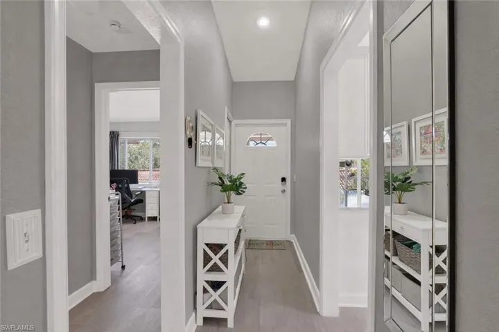 Entrance foyer featuring light wood-style floors and a textured wall