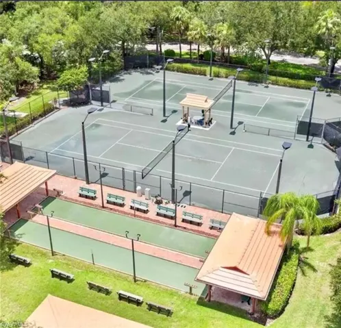 View of tennis court featuring a patio area