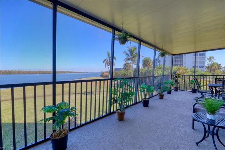 Sunroom featuring a water view