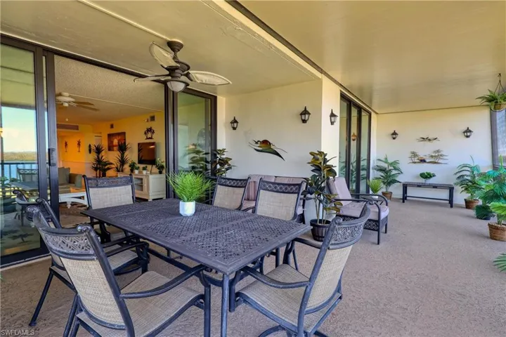 View of patio with outdoor dining space and a ceiling fan
