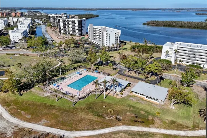 View of urban area featuring a pool and a large body of water